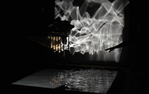 Light sculpture installation projecting water ripples using light and sound