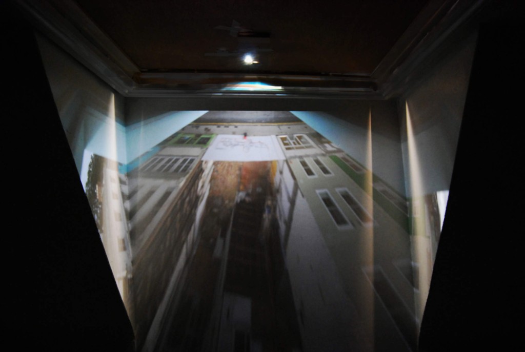 Projection of a film onto the walls of Kate's studio space showing a tall building projected