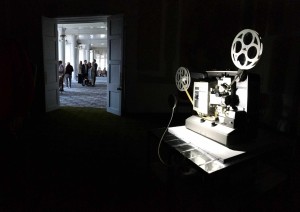 Close-up of vintage film projector illuminated by bright spotlight