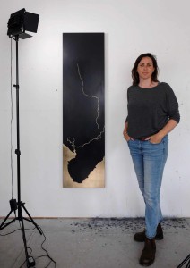 Photo of Kate with the artwork hung on her studio wall