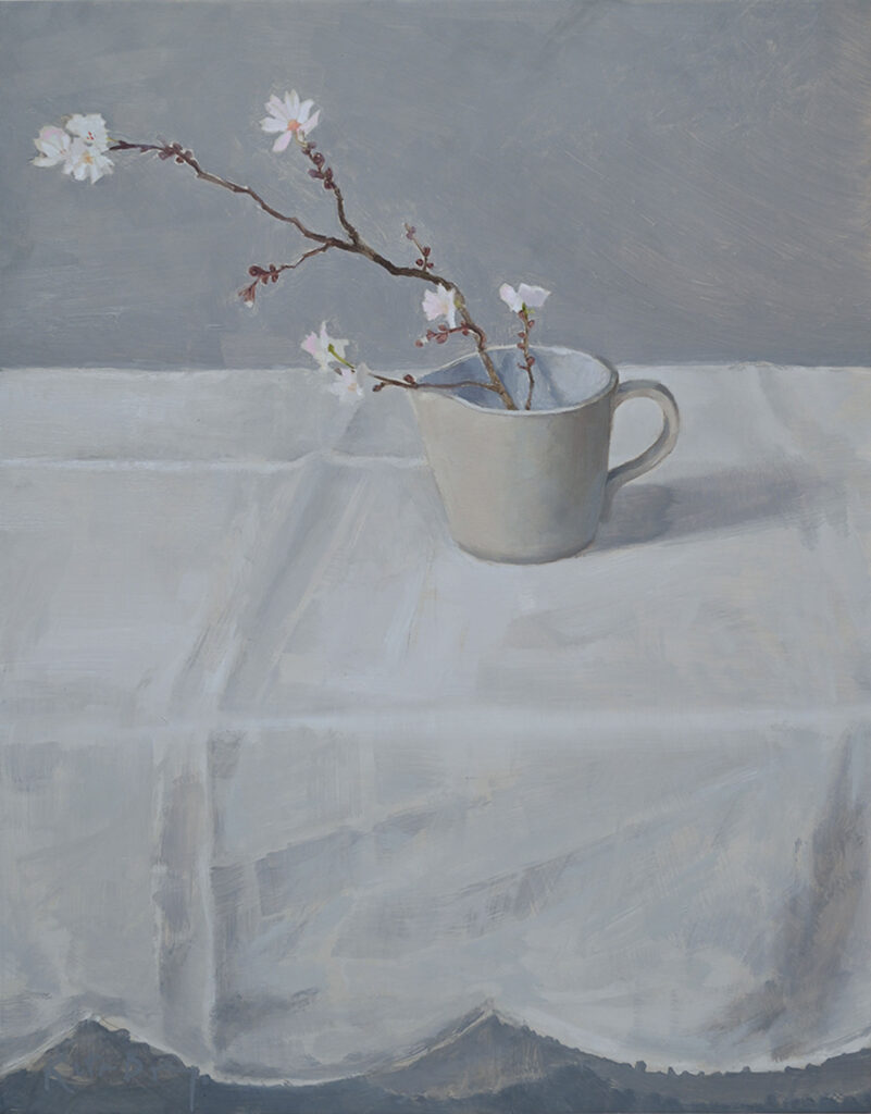 Soft, pale painting of a spring of blossom in a pale cream jug, on a white table cloth with scalloped edge hanging over the front the table.