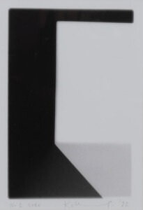 The edge of a white cube who's pale grey shadow goes away from the bottom of the square towards the right hand corner. The work has a white border and the artist's signature and the title of the work can be seen written in pencil at the bottom of the piece.